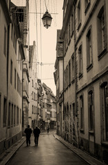 Rainy street in France, vertical, in sepia
