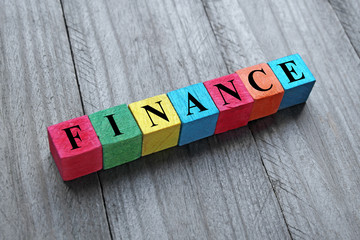 concept of finance word on colorful wooden cubes