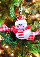 Smiling snowman hanging on a Christmas tree