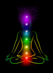 Woman silhouette on the black background with shining chakras