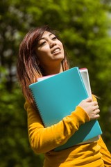 Fototapeta premium Female college student with books in park