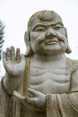 Fototapeta premium Close up view of a beautiful Buddha statue on a park.
