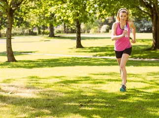 Fit blonde jogging in the park