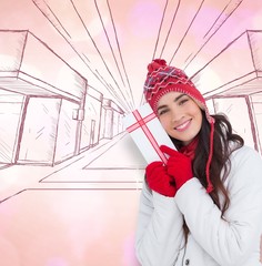 Festive brunette in winter clothes pointing gift