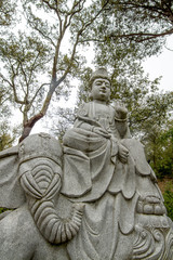 Fototapeta na wymiar Close up view of a beautiful Buddha statue on a park.