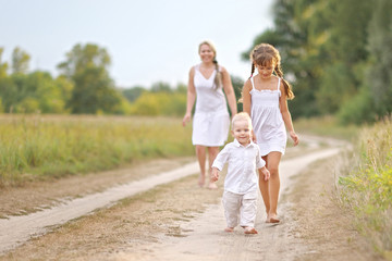 Mom with son and daughter in summer nature