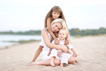 Mom with son and daughter in summer nature