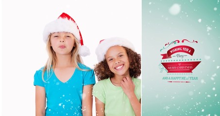 Composite image of cheerful girls with christmas hats