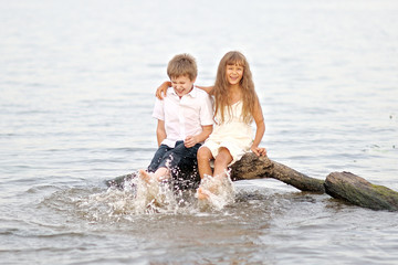 Portrait of a boy and girl playing on the beach