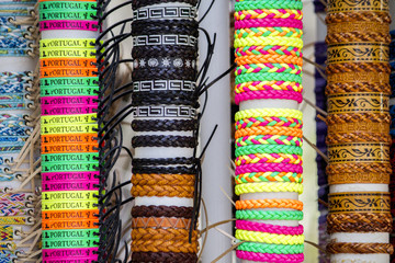 Close up view of many various leather and textile bracelets.