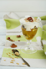 Tasty dessert with oat flakes and honey, on table