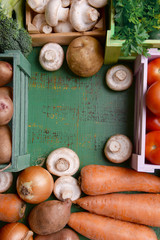 Different vegetables in boxes on wooden background top view