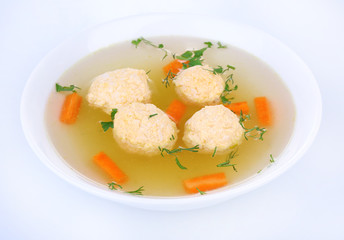 Soup with meatballs in bowl isolated on white