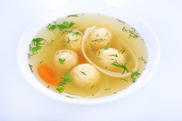 Soup with meatballs and noodles in bowl isolated on white