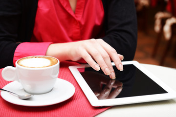 Woman with tablet computer in cafe shop