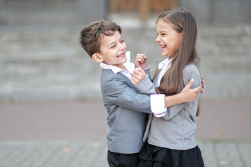 Portrait of a boy and a girl in school suit