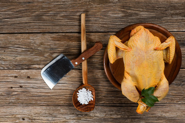 uncooked  chicken on a old wooden table, top view