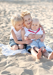 portrait of three little boys on the beach in summer