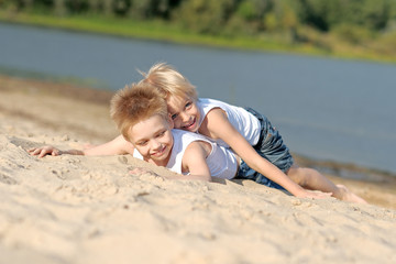 portrait of two little boys on the beach in summer