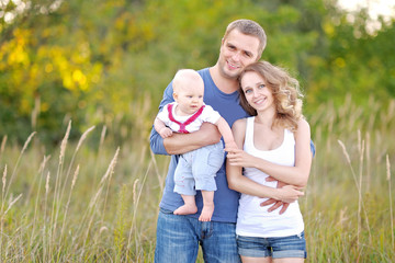 Fototapeta premium portrait of a happy family on summer nature