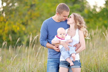 portrait of a happy family on summer nature