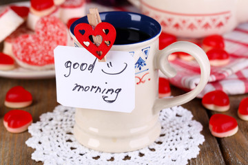 Cup of tea with card that says good morning on table close-up