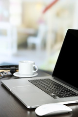 Modern laptop on table, on light background