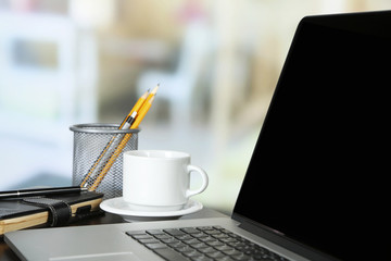 Modern laptop on table, on light background