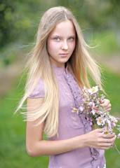 portrait of a beautiful young girl with a bouquet of flowers
