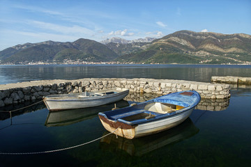Fototapeta na wymiar two boats in dock and mountains