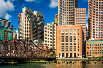 Fototapeta premium An old bridge and the Boston Skyline, seen from Fort Point.