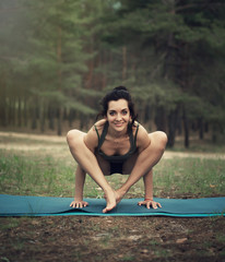 beautiful girl is engaged in yoga in the forest