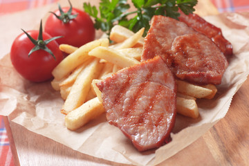 Grilled ham slices with french fries