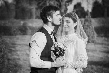 Romantic wedding couple embracing at each other