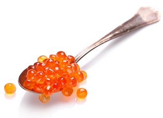 Red caviar in the silver spoon isolated on a white background.
