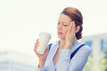 Woman stressed by mistake having headache drinking coffee