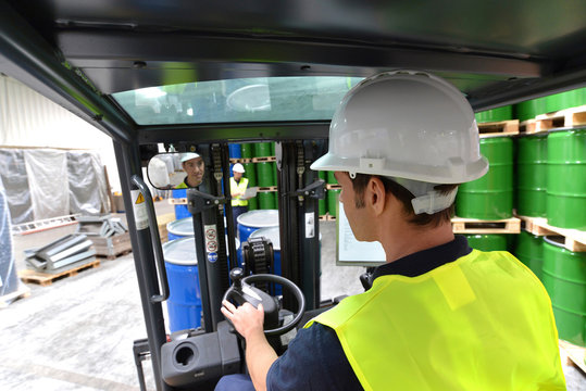 Driver of a forklift in the warehouse // Gabelstaplerfahrer