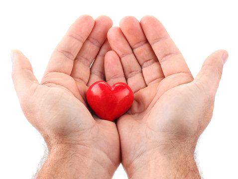 Red heart in male hands.