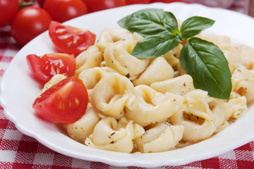 Tortellini pasta with tomato and basil