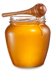 Glass can full of honey and wooden stick on it. Clipping paths.