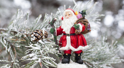 Toy Santa Claus on the fir tree branch