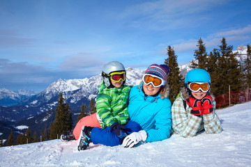 Fototapeta na wymiar Two kids with mother enjoying winter vacations.