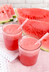 Juicy watermelon on table on brick wall background