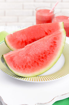 Juicy watermelon on table on brick wall background