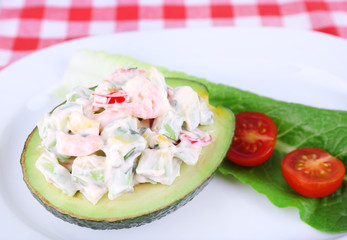 Tasty salad in avocado on plate table close-up