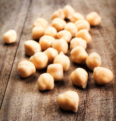 Golden  Chickpeas over rustic wooden table close up.  Traditiona