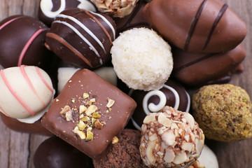 Many chocolate candy on wooden rustic background