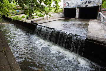 Water stream flowing out the underground tunnel