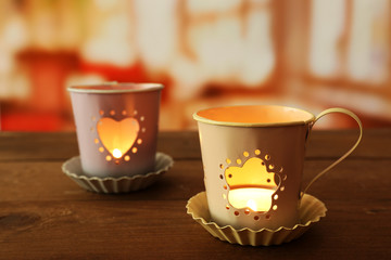 Tow lanterns on wooden surface and blurred background