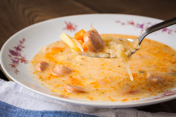 Frankfurter soup on a spoon, closeup